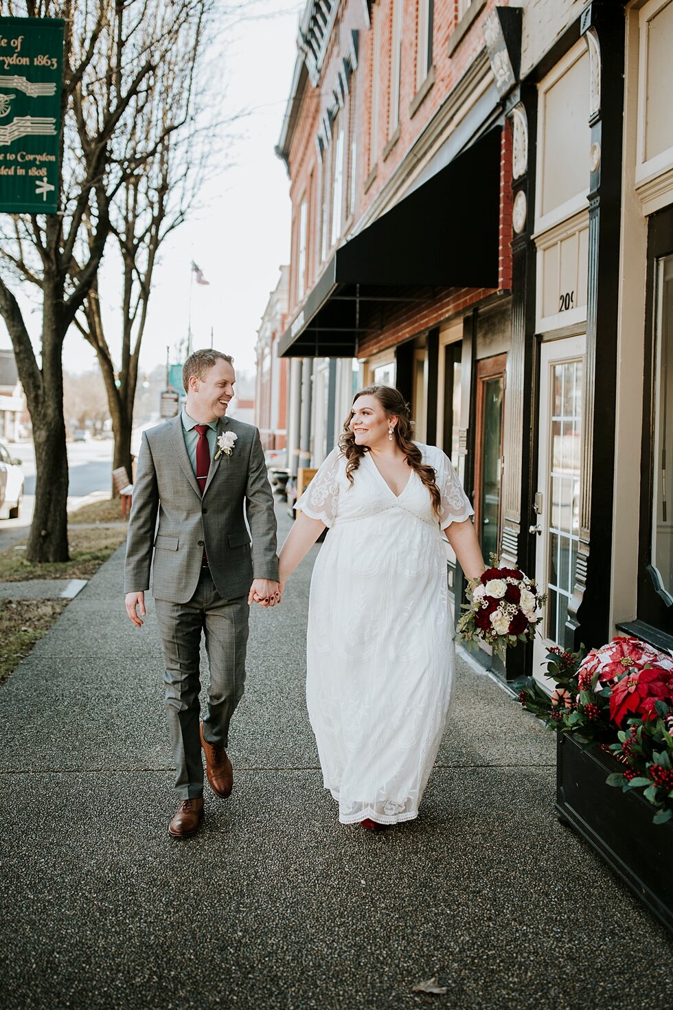  Walking hand in hand down historic downtown Corydon, Indiana just hours before they tied the knot as husband and wife during their intimate winter backyard wedding with their closest friends and family. Southern wedding Indiana intimate wedding smal