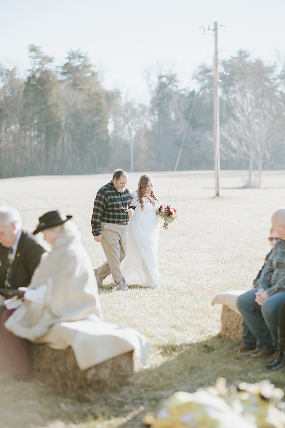  The bride walking down the intimate aisle with her father as the micro wedding began on this winter wedding day in Corydon, Indiana. Southern wedding Indiana intimate wedding small ceremony microceremony corydon indiana professional photographer #wi