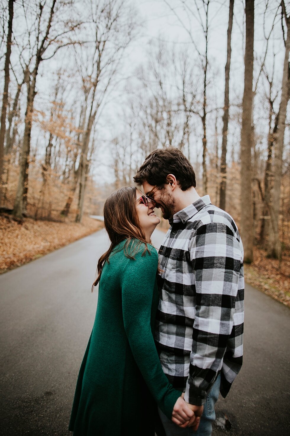  Stunning emerald green dress worn during rainy winter engagement and save the date photography session. Louisville photographer winter engagement Bernheim Forest emerald green dress plaid shirt rainy day Kentucky couple outdoor engagement  #savethed