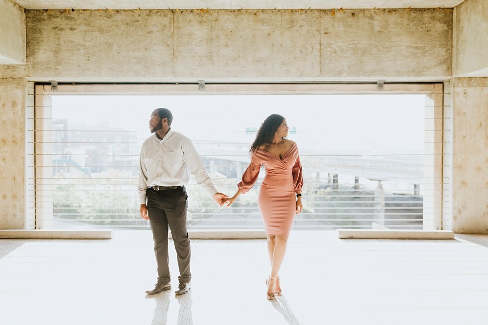  Holding hands in this spring urban engagement session is this African American couple in downtown Louisville Muhammad Ali center and belvedere #engaged #muhumadalicenter #belvedere #shesaidyes #engaged #padbl #photographyanddesignbylauren #urban #ci