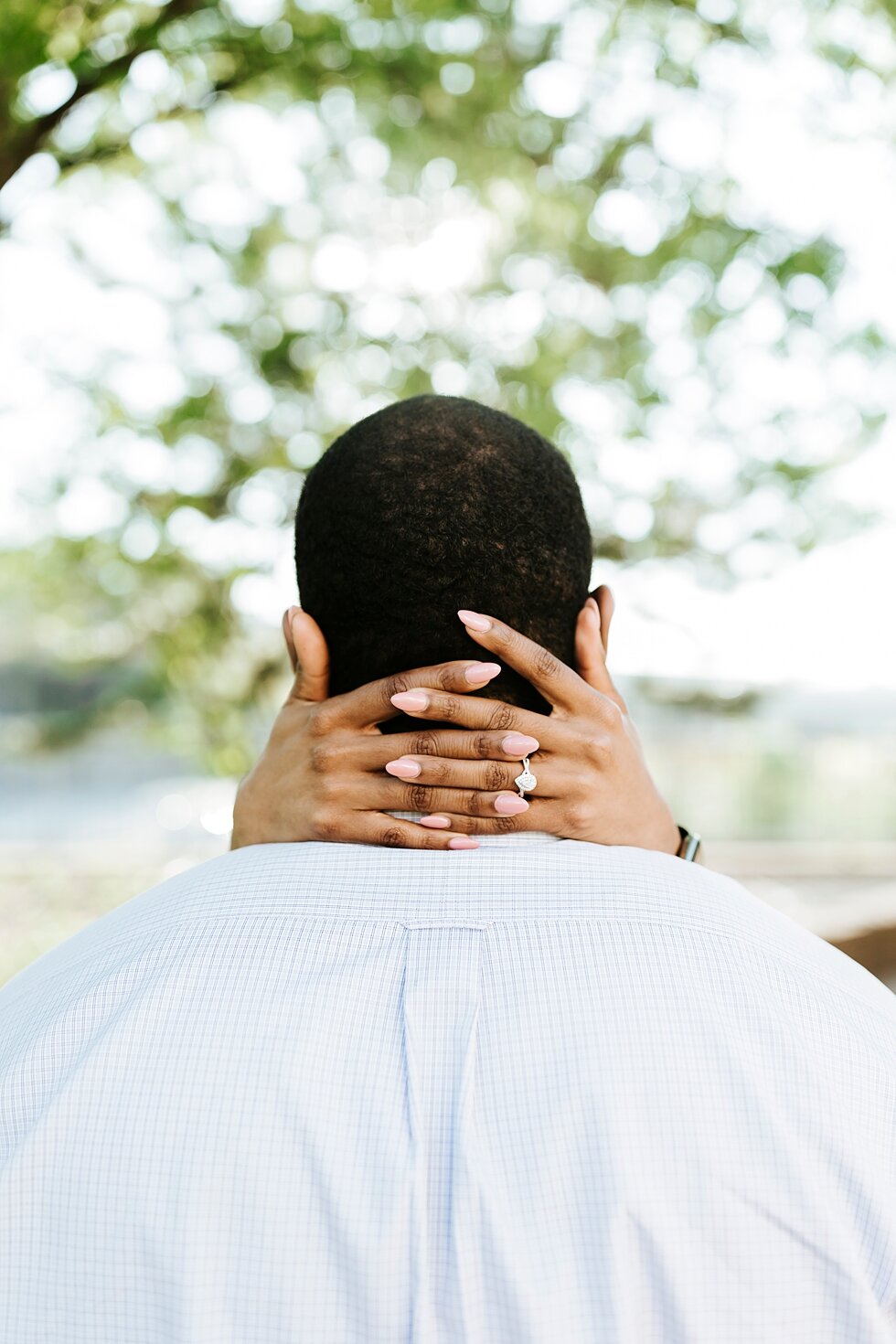  Hands locked around his neck, this African American couple was filled with love during their urban engagement pictures in downtown Louisville Muhammad Ali center and belvedere #engaged #muhumadalicenter #belvedere #shesaidyes #engaged #padbl #photog