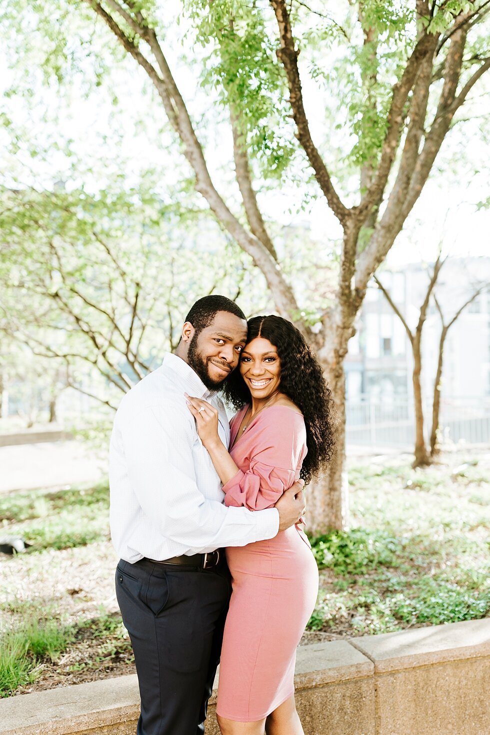  Smiling and holding each other close this African American couple urban engagement pictures in downtown Louisville Muhammad Ali center and belvedere #engaged #muhumadalicenter #belvedere #shesaidyes #engaged #padbl #photographyanddesignbylauren #urb