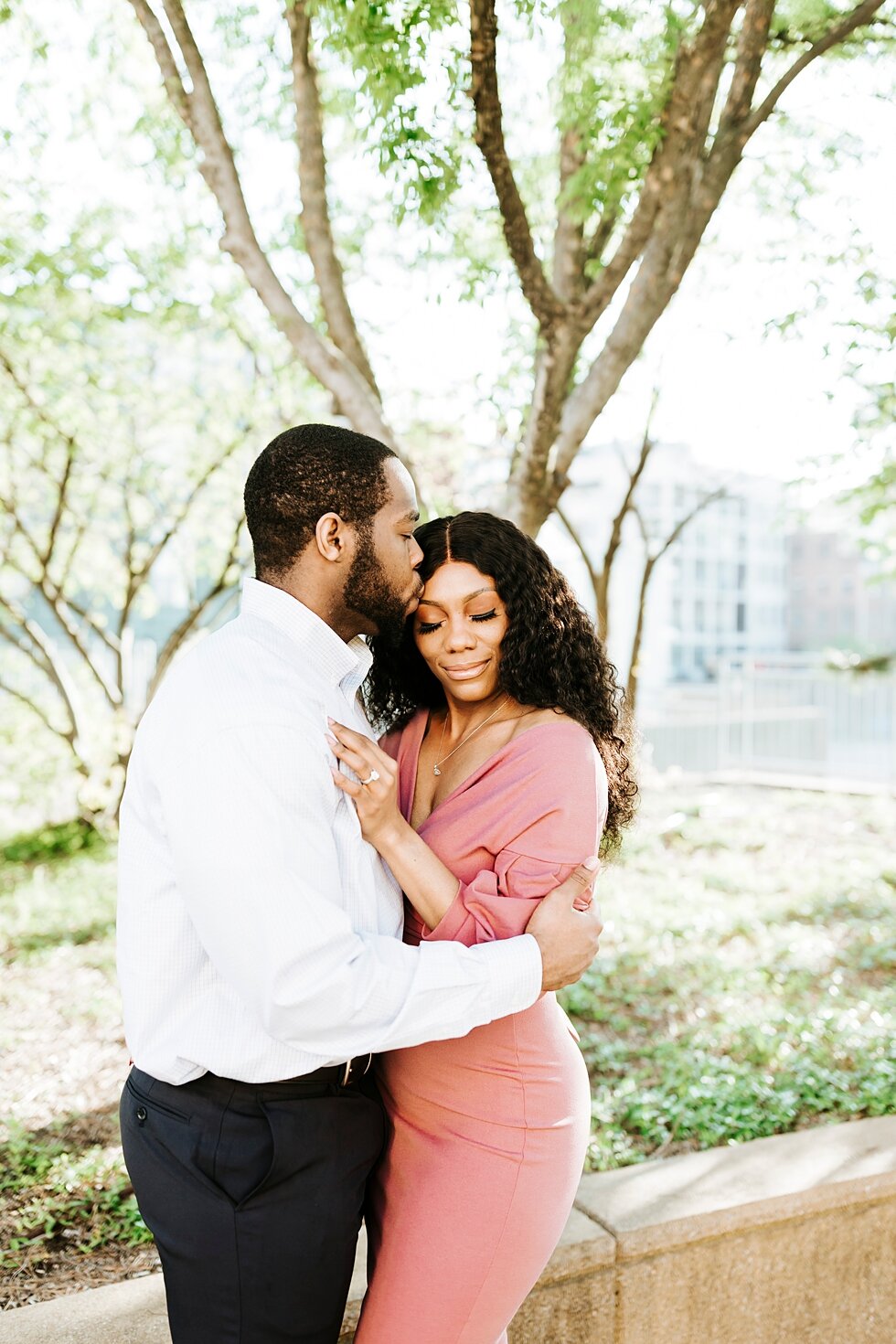  Sweet kiss on the forehead as this African American couple urban engagement pictures in downtown Louisville Muhammad Ali center and belvedere #engaged #muhumadalicenter #belvedere #shesaidyes #engaged #padbl #photographyanddesignbylauren #urban #cit