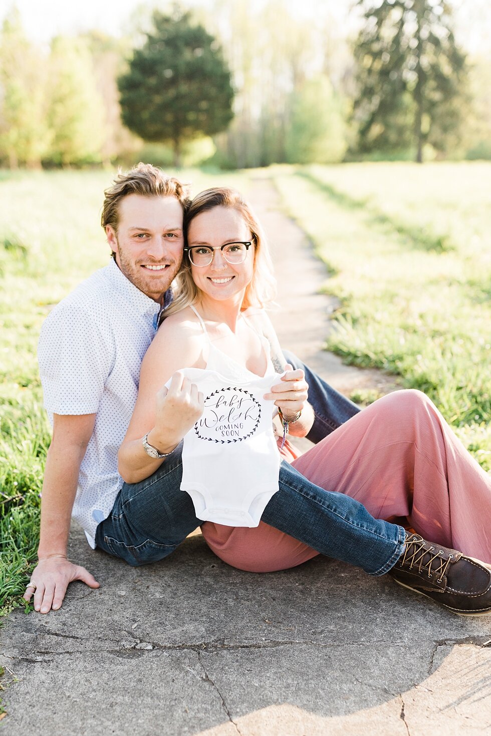  Smiling with a cute onesie for their baby who is on the way! announcement for a southern spring session. couple baby on the way expecting excited maternity photography congratulations announcement baby coming soon #padbl #padblmaternity #padblmatern