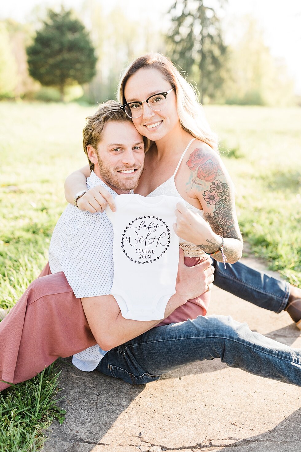  Nothing better than a onesie to announce that there is a baby in the wings waiting to join this cute couple! announcement for a southern spring session. couple baby on the way expecting excited maternity photography congratulations announcement baby