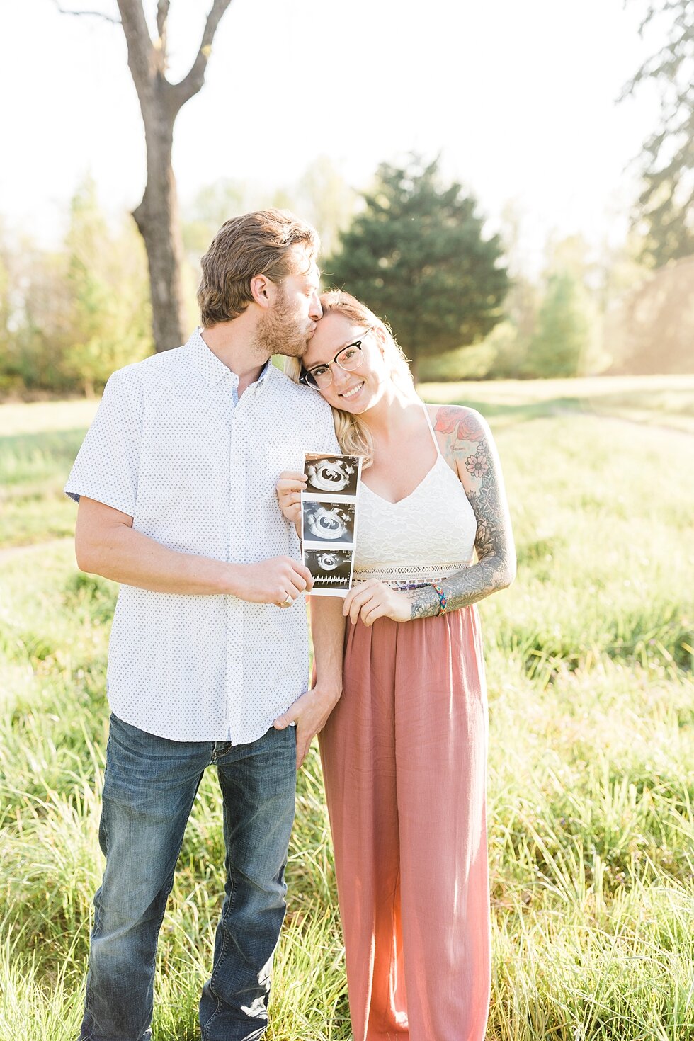  Kiss on the forehead as this couple shares their excitement and big news about having a baby on the way! ultrasound announcement for a southern spring session. couple baby on the way expecting excited maternity photography congratulations announceme