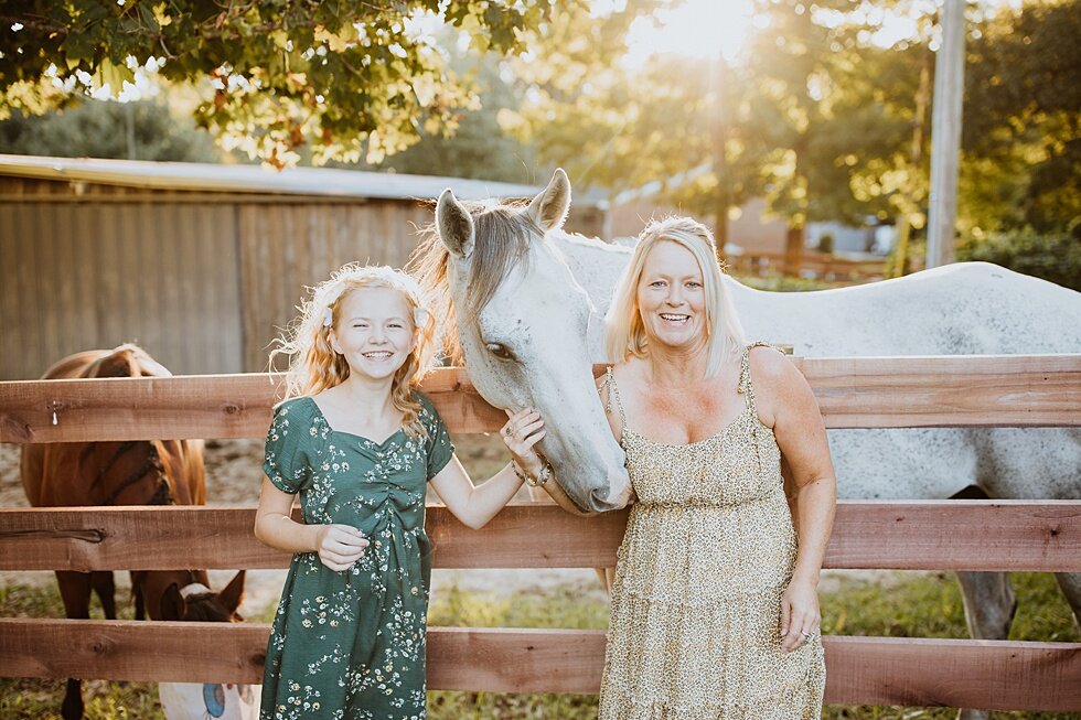  Stunning mother and daughter posing in from of the fence for their lovely white horse in Louisville, Kentucky. Fall Louisville Kentucky photographer mother daughter photography session portraits loving relationship western girls country roots #mothe