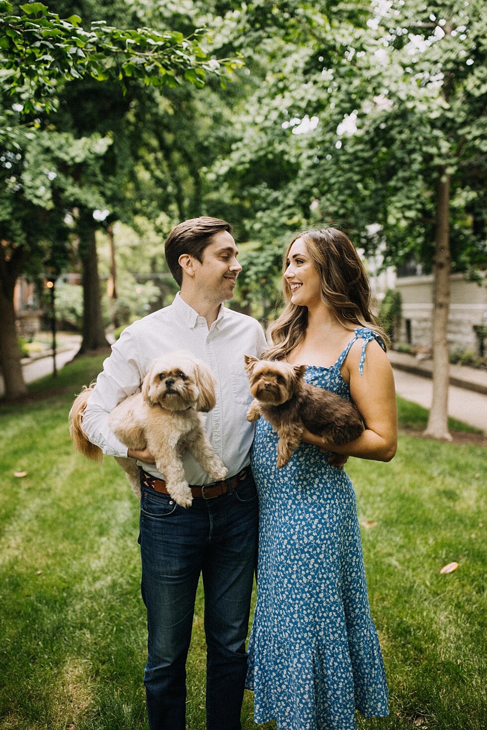  Gazing into each others eyes in this beautiful lush green garden holding their furry family while they take engagement photos and get ready to tie the knot as husband and wife. #engagementphotos #savethedatephotos #savethedates #engagementphotograph