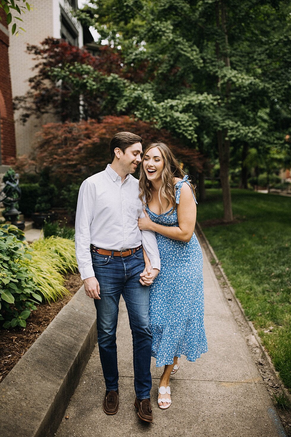  Natural laugh shared between these two as they walk down the pathway in the St James Court gardens. Stunning blue dress semi formal  urban engagements #engagementphotos #savethedatephotos #savethedates #engagementphotography  #StJamesCourt #gardenen