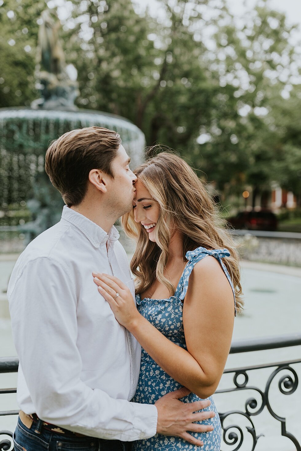  Kiss on the forehead as this engaged couple shared their engagement shoot in front of the beautiful St James Court water fountains. #engagementphotos #savethedatephotos #savethedates #engagementphotography  #StJamesCourt #gardenengagment   #centralp