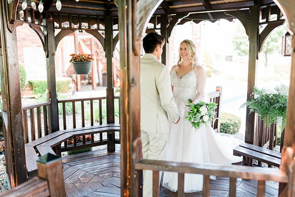  Preparing to be husband and wife, this couple gathered together under this beautiful gazebo. Romantic casual lace wedding gown close friends neutral colors background wedding natural greenery crisp white #midwestphotographer #kywedding #louisville #