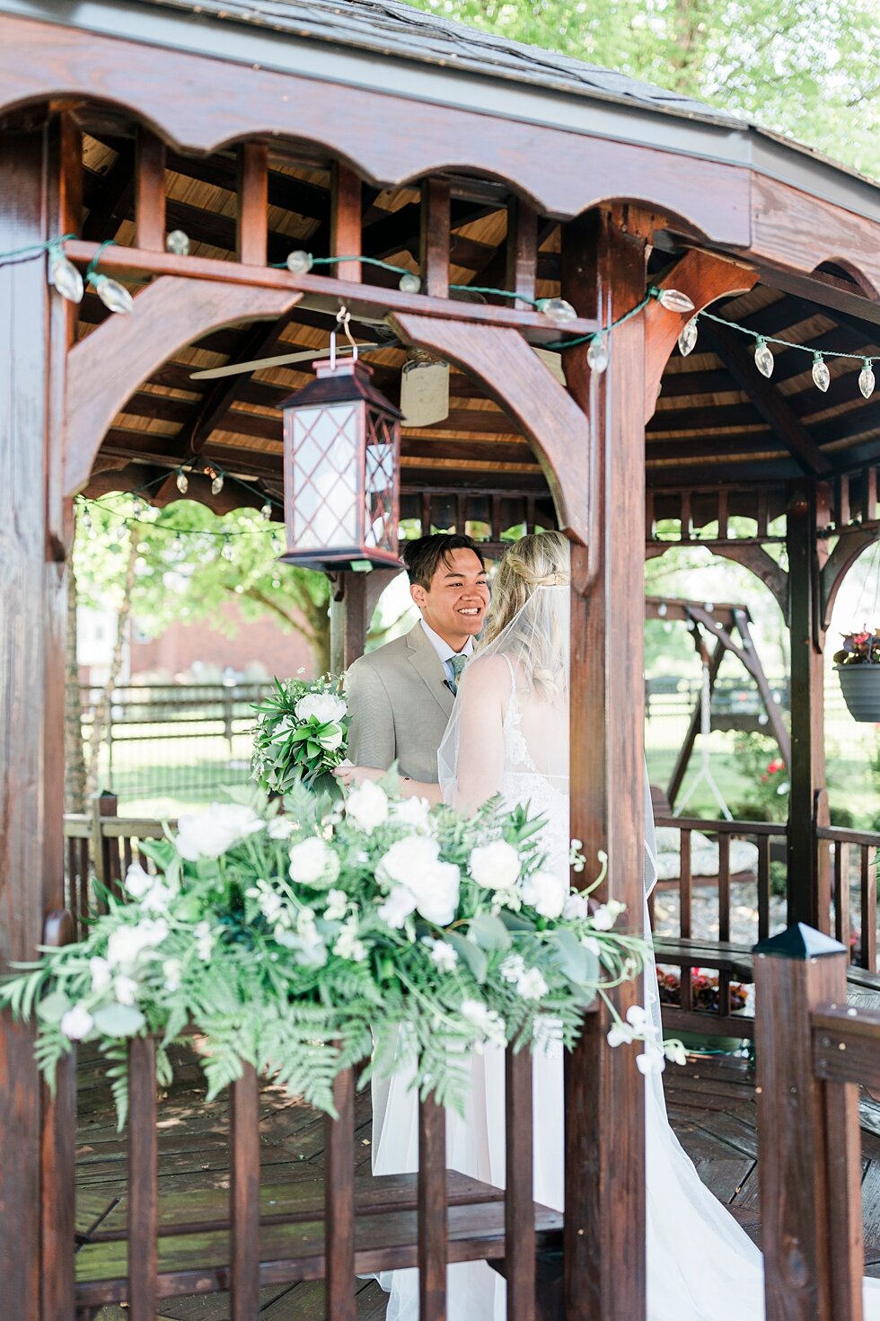  Natural lighting and natural colors helped accent this couple as they met under this beautiful gazebo! Romantic casual lace wedding gown close friends neutral colors background wedding natural greenery crisp white #midwestphotographer #kywedding #lo
