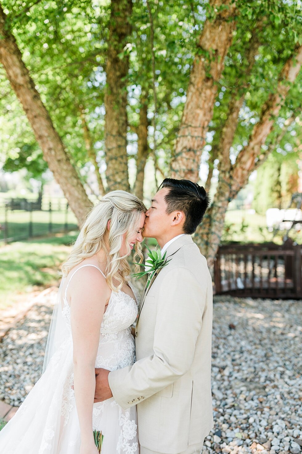  Sweet kiss on the forehead for this couple. Romantic casual lace wedding gown close friends neutral colors background wedding natural greenery crisp white #midwestphotographer #kywedding #louisville #kentuckywedding #louisvillekyweddingphotographer 