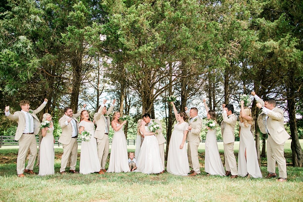  From the brides side to the grooms, this couple had so many wonderful people to support them on their big day including the entire wedding party! Romantic casual lace wedding gown close friends neutral colors background wedding natural greenery cris