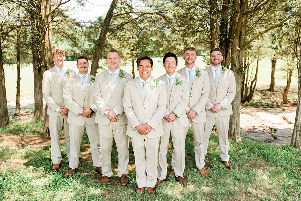  This groom had quite the support system of groomsmen behind him to celebrate his big day becoming a husband! Romantic casual lace wedding gown close friends neutral colors background wedding natural greenery crisp white #midwestphotographer #kyweddi