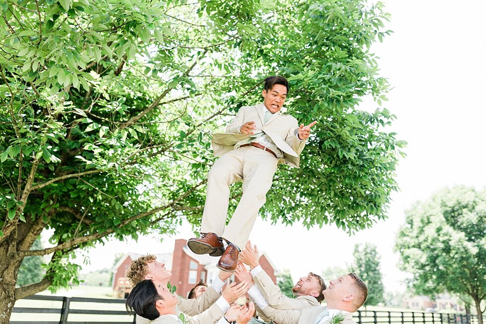  This groom had quite the support system of groomsmen behind him to celebrate his big day becoming a husband! Romantic casual lace wedding gown close friends neutral colors background wedding natural greenery crisp white #midwestphotographer #kyweddi