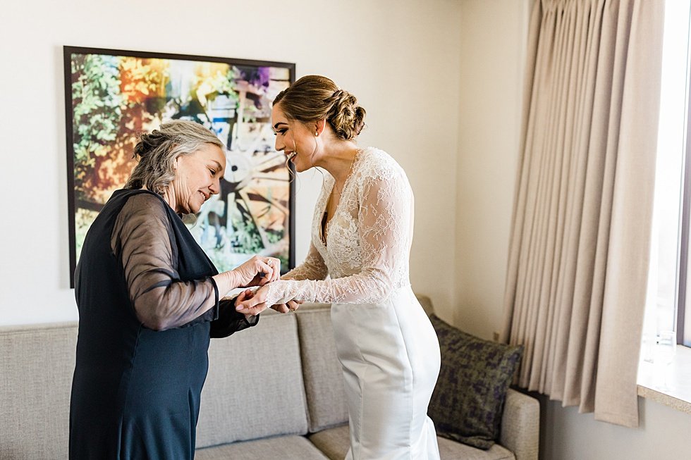  Bride getting ready with bridesmaids on wedding day at Galt House Hotel. Lauren and Adam's winter wedding at St Agnes Catholic church and the Frazier History Museum. 