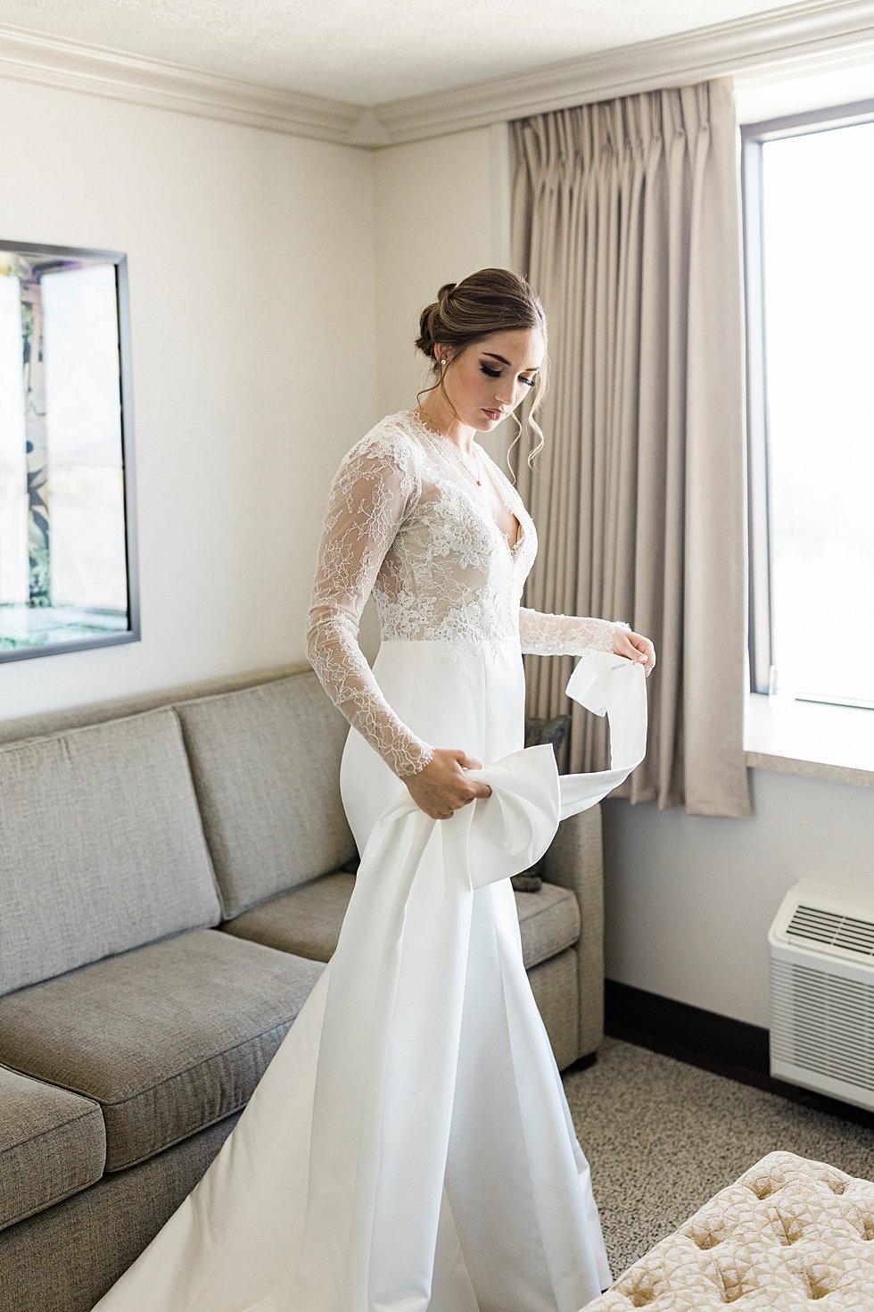  Bride getting ready with bridesmaids on wedding day at Galt House Hotel. Lauren and Adam's winter wedding at St Agnes Catholic church and the Frazier History Museum. 