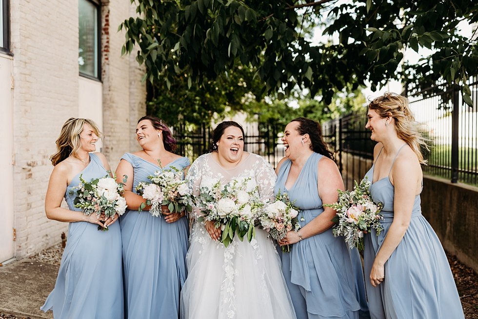  Bride and Bridesmaids with bouquets on wedding day. Spring wedding at The Refinery Jeffersonville, Indiana 