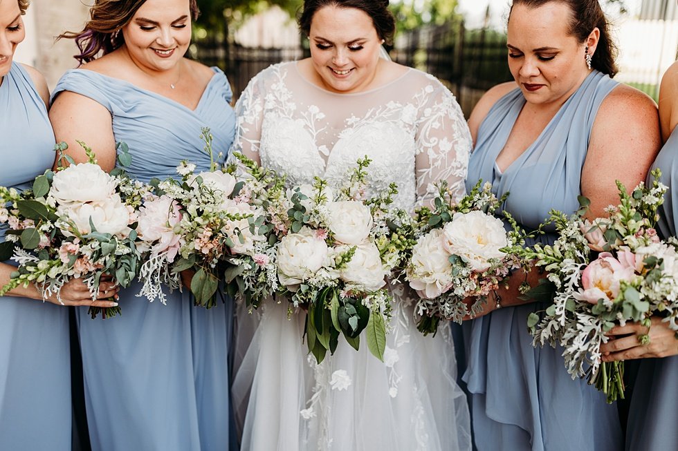  Bride and Bridesmaids with bouquets on wedding day. Spring wedding at The Refinery Jeffersonville, Indiana 