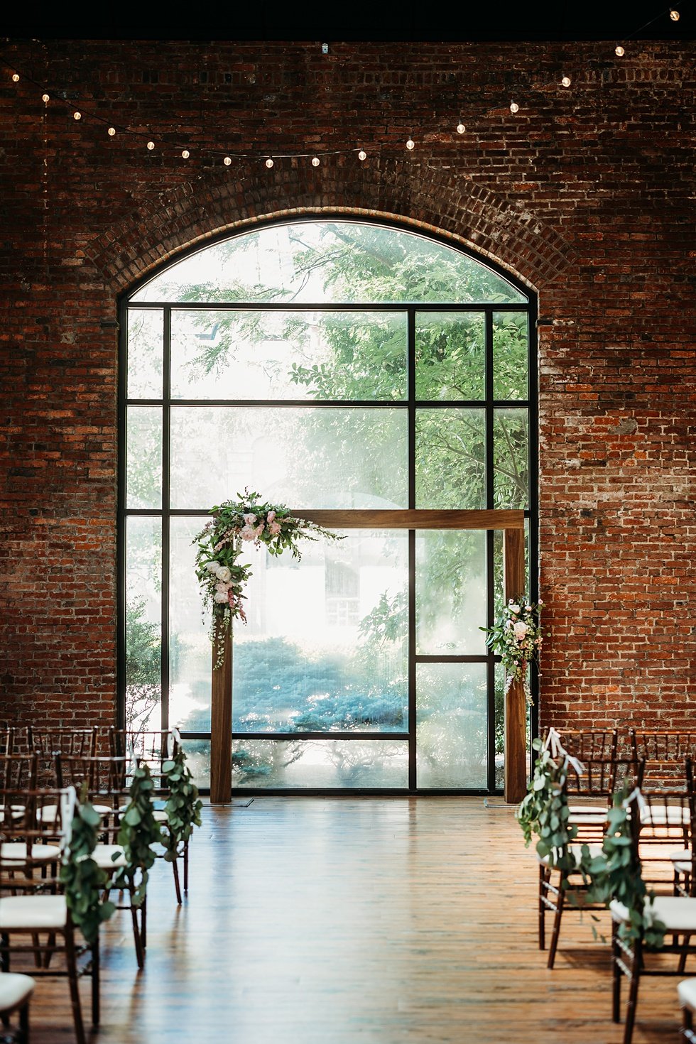  Ceremony set up with rustic wood arch at the refinery. Spring wedding at The Refinery Jeffersonville, Indiana 