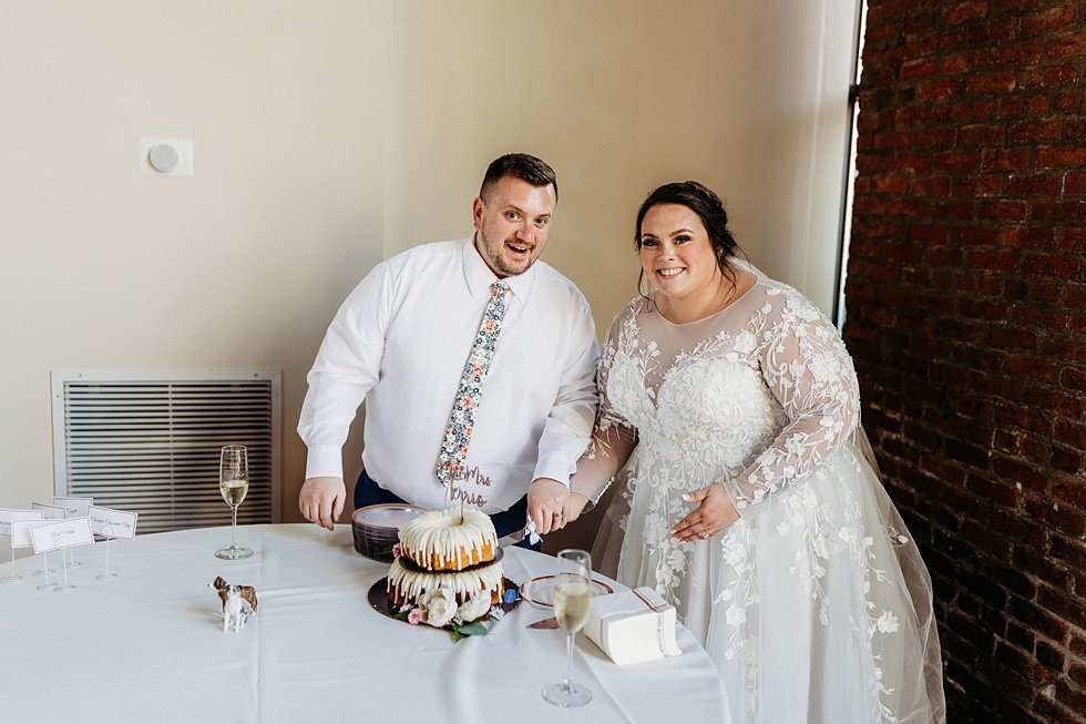  Bride and Groom cuting cake. Spring wedding at The Refinery Jeffersonville, Indiana 