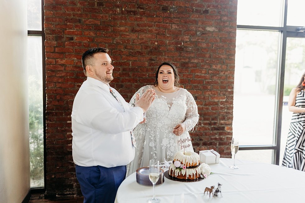  Bride and Groom cuting cake. Spring wedding at The Refinery Jeffersonville, Indiana 