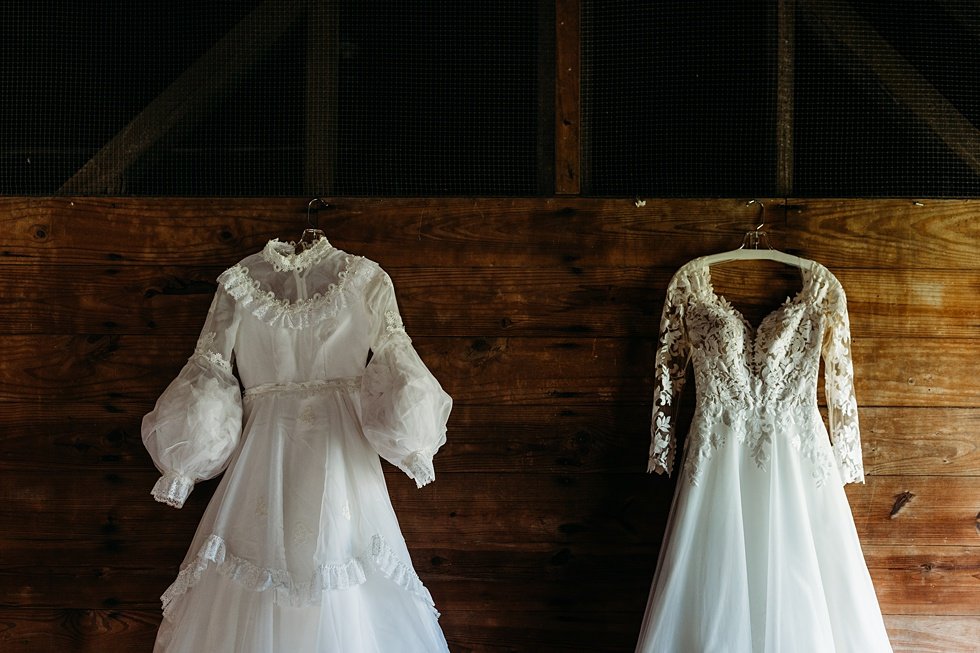  Bride's wedding dress haning next to her mother's. Outdoor summer wedding at Villwock Farms , Edwardsport, IN 