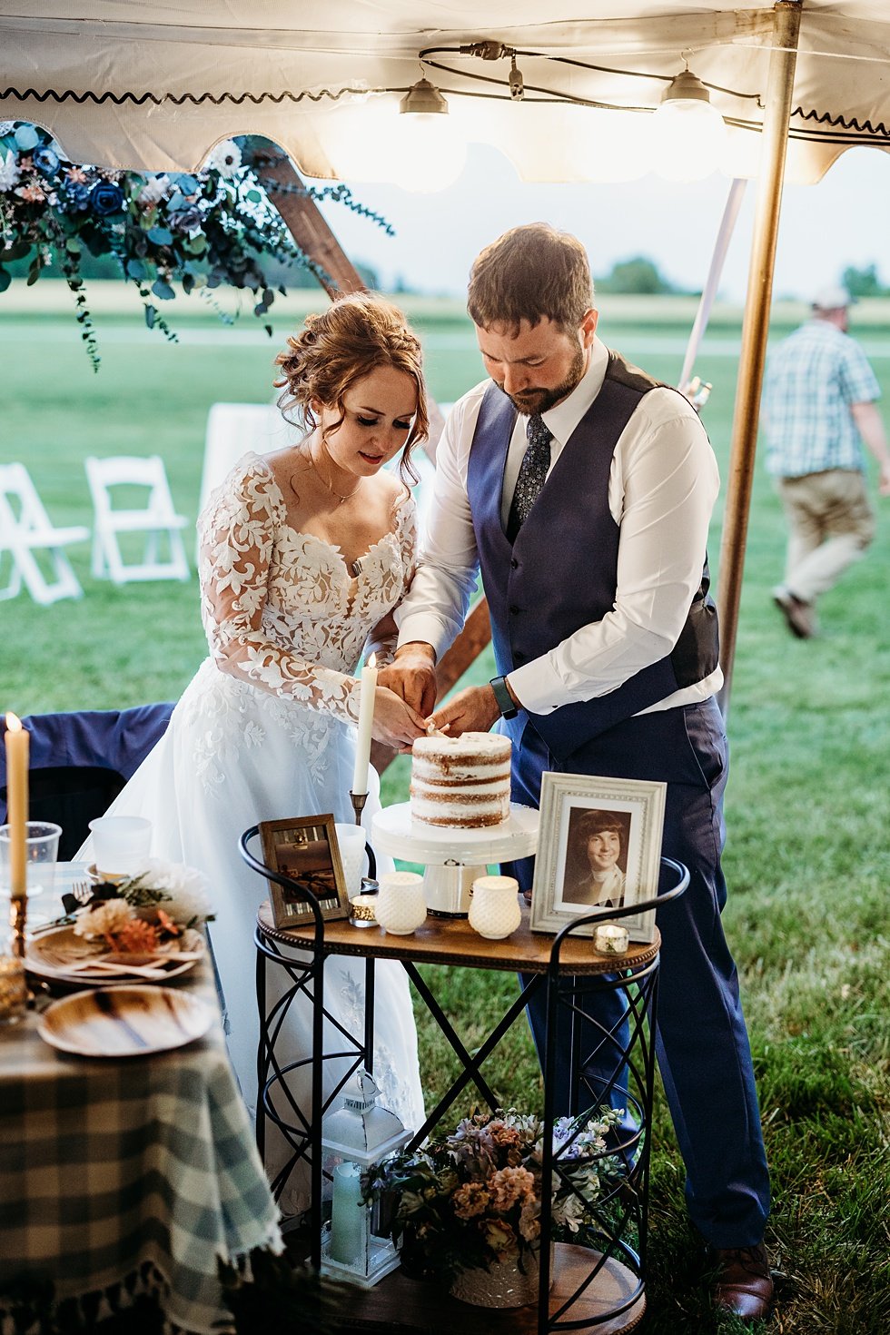  Bride and groom cut cake. Outdoor summer wedding at Villwock Farms , Edwardsport, IN 