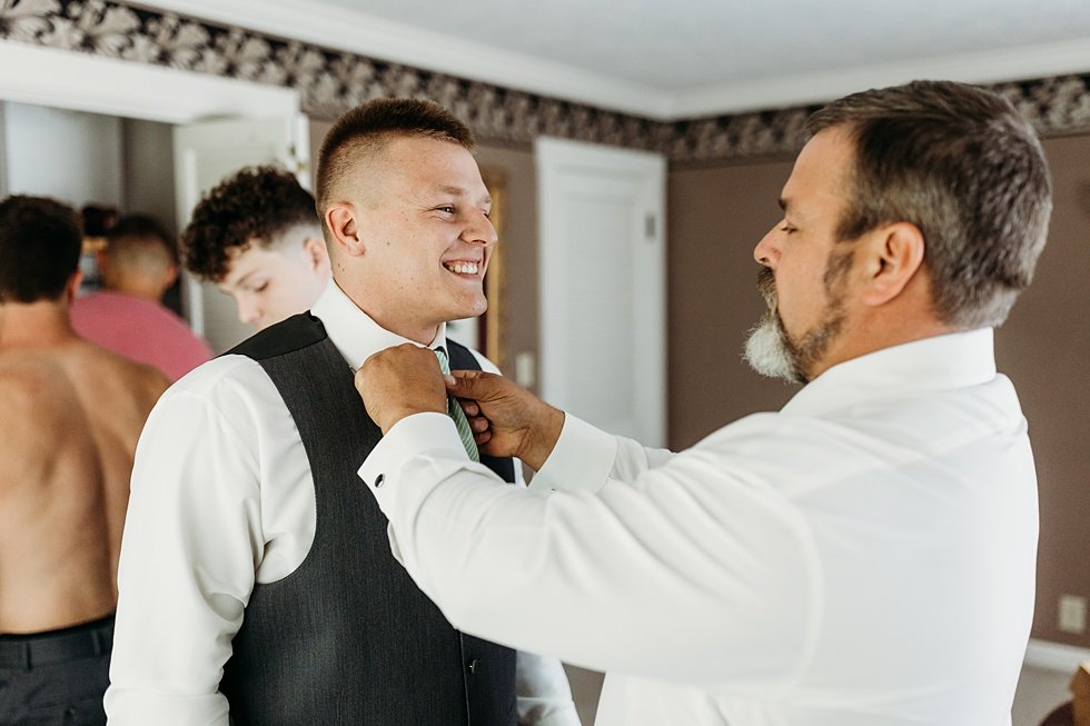  Groom gwtting ready with groomsmen in bridal house at Huber's Orchard and Winery in Starlight, Indiana. 
