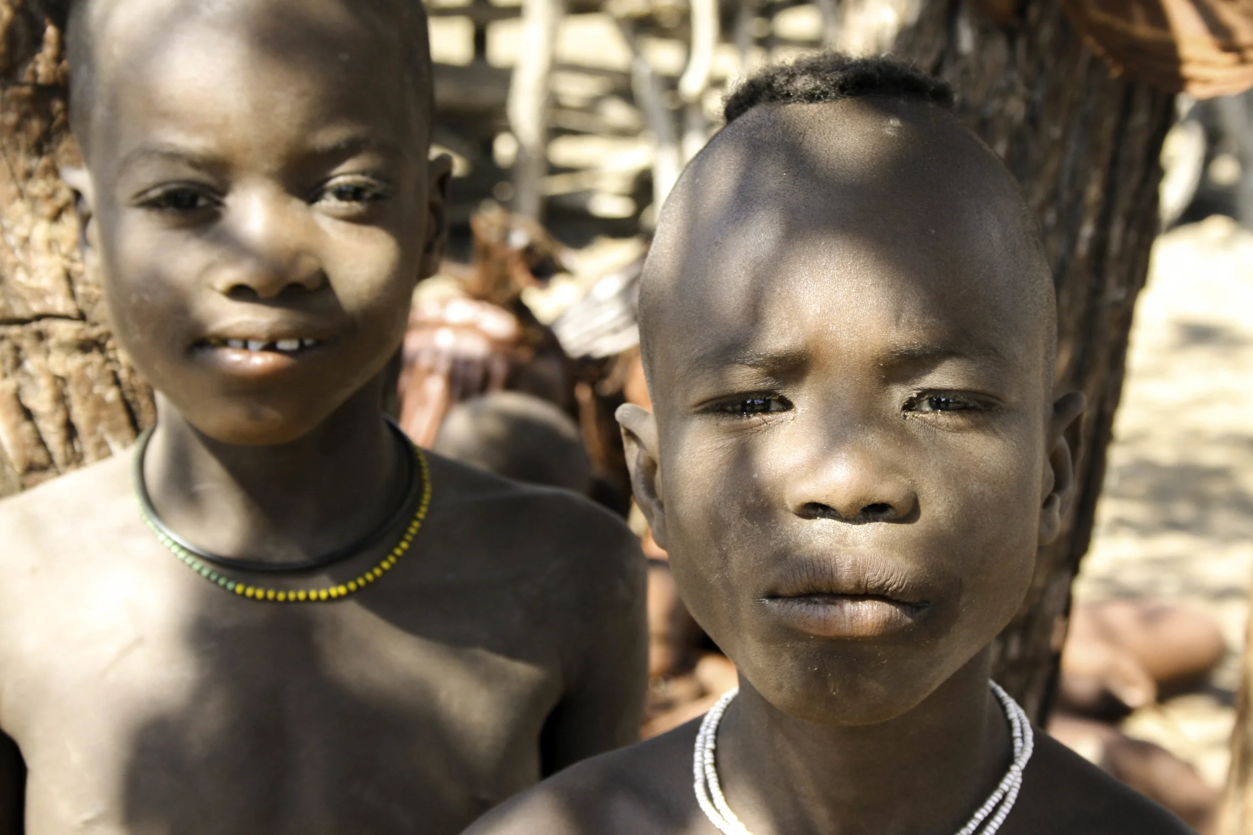 Angola/Namibia Border. Sons of the sheepherding Himba tribe. The elder men in the village had been away for two months to attend the funeral of another Himba hief in Angola. These boys stayed behind to tend the goats whose milk the family depends on for food.