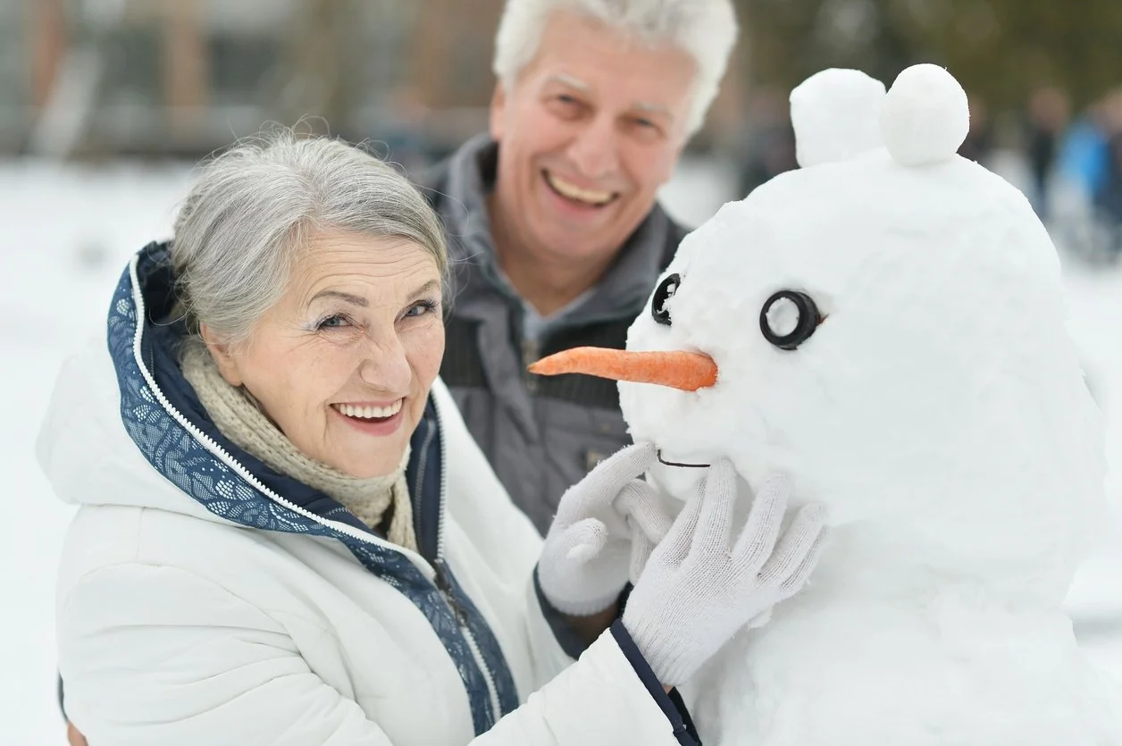 iStock-502156756_senior-couple-outside-snowman.jpg