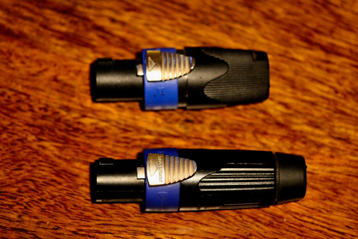 One of these is a Neutrik Speakon connector. The other is Karma.