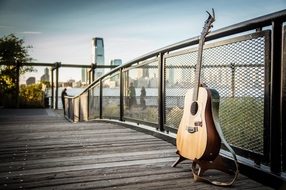 We met up a few days beforehand to scout locations and finally decided on a small bridge right on the water in Battery Park City. On the day of, I arrived a few minutes early, hid, and waited. As they walked up, saw the guitar, and Robbie started to sing, Ellie knew exactly what was happening.