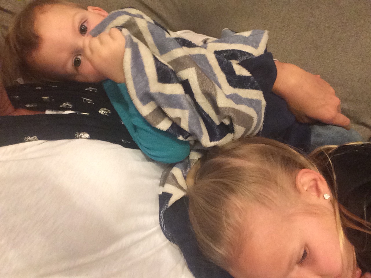 Kycie and Boston laying on Jamie after church. Kycie had just complained of a headache.