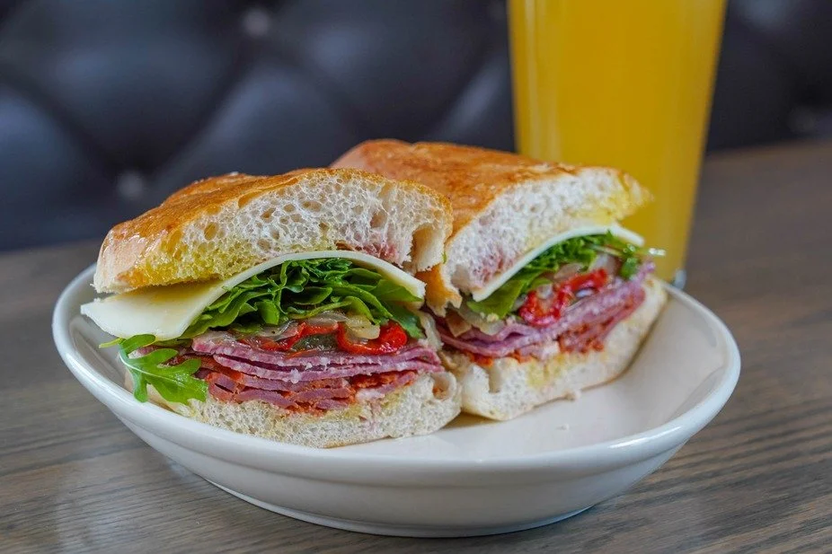 Relish a hearty sandwich stacked with fresh ingredients, perfectly paired with a refreshing drink.

#FirstAndLastTavernPlainville #ExplorePlainville #BarAndRestaurant #HeartySandwich #CreativeFood #BarAndGrill