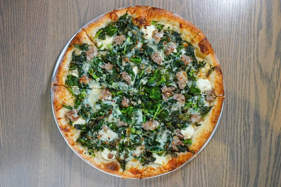 Enjoy the rich flavors of our coal oven pizza topped with fresh greens and savory sausage.

#FirstAndLastTavernPlainville #ExplorePlainville #BarAndRestaurant #CoalOvenPizza #HeartyEats #BarAndGrill
