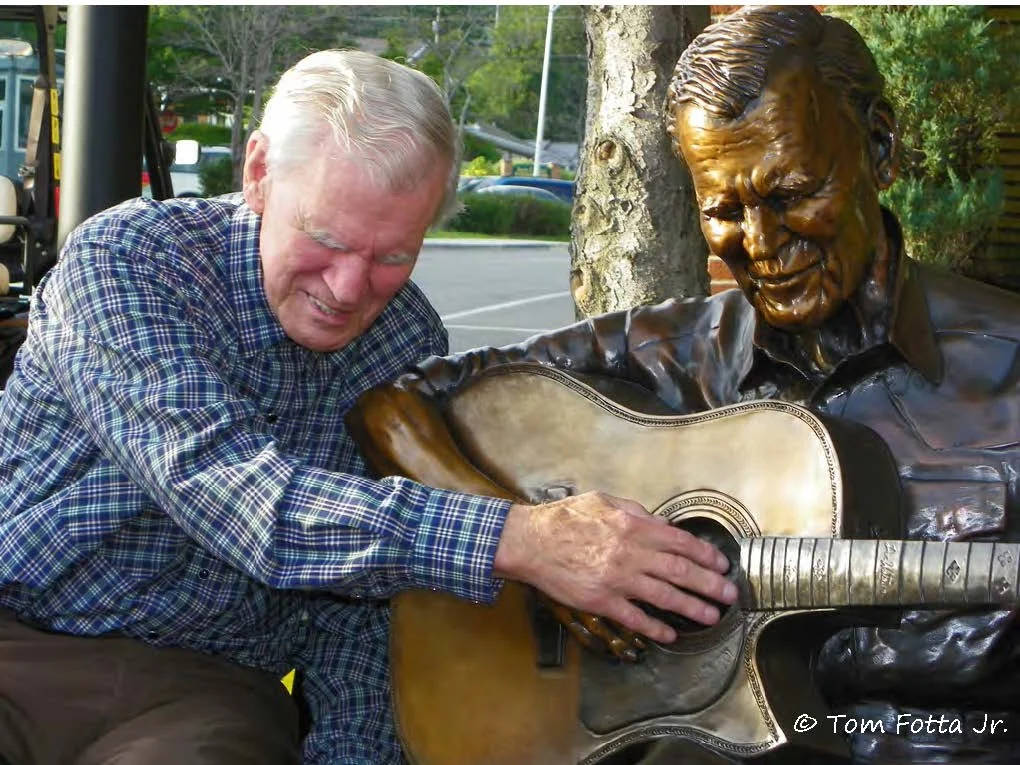 Doc with his statue. Photo by Tom Fotta Jr.