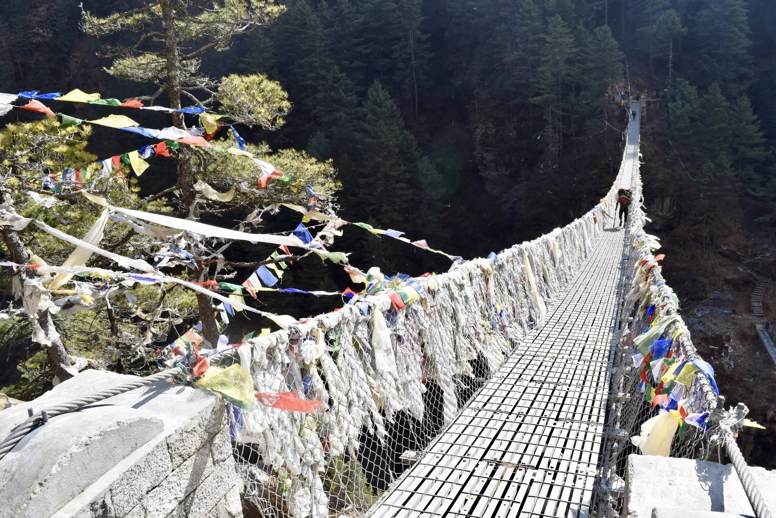 Suspension bridge with prayer flags on the way to Namche