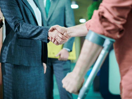 An injured plaintiff shaking hands with a personal injury lawyer