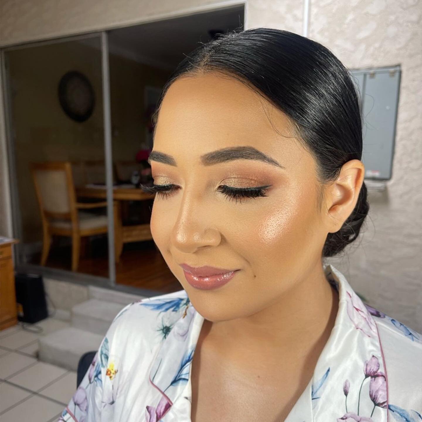 We summered up her Smokey bronze wedding day glam by adding some peach tones to her lips and cheeks.