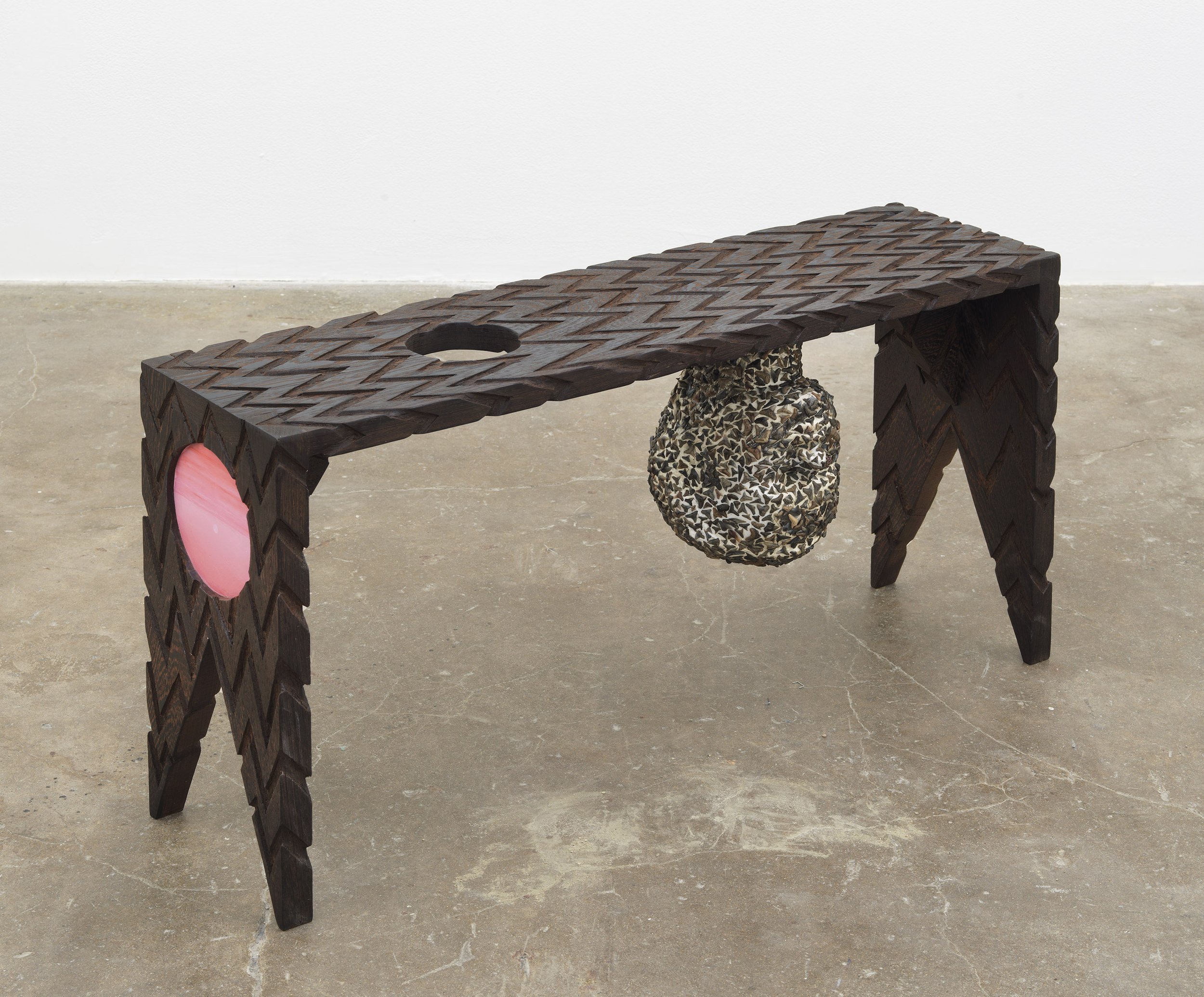   Nether Eye Looking Bench , 2020, fossils, pencil, acrylic, oil, and found objects on carved wenge, 17” x 31.5” x 8.5” 