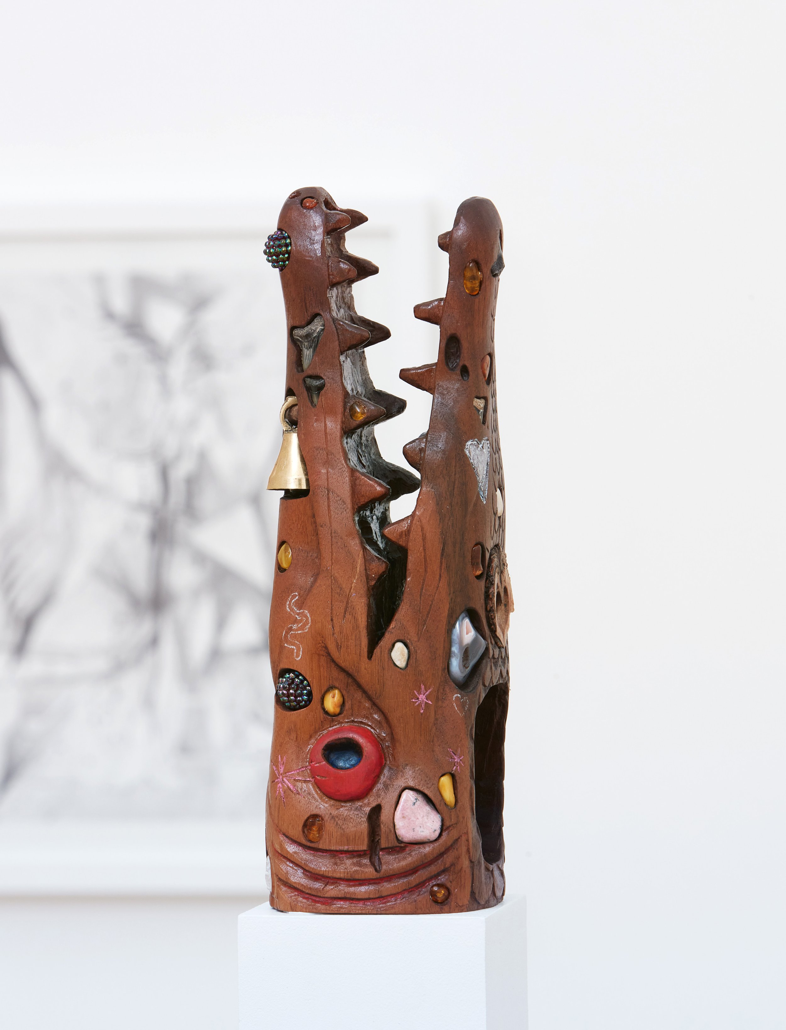   Alligator Gar , 2019 - 2022, fossils, rocks, crystals, amber, beads, nut, plastic toy, metal bell, and colored pencil on carved walnut, 10.5" x 4" x 4 