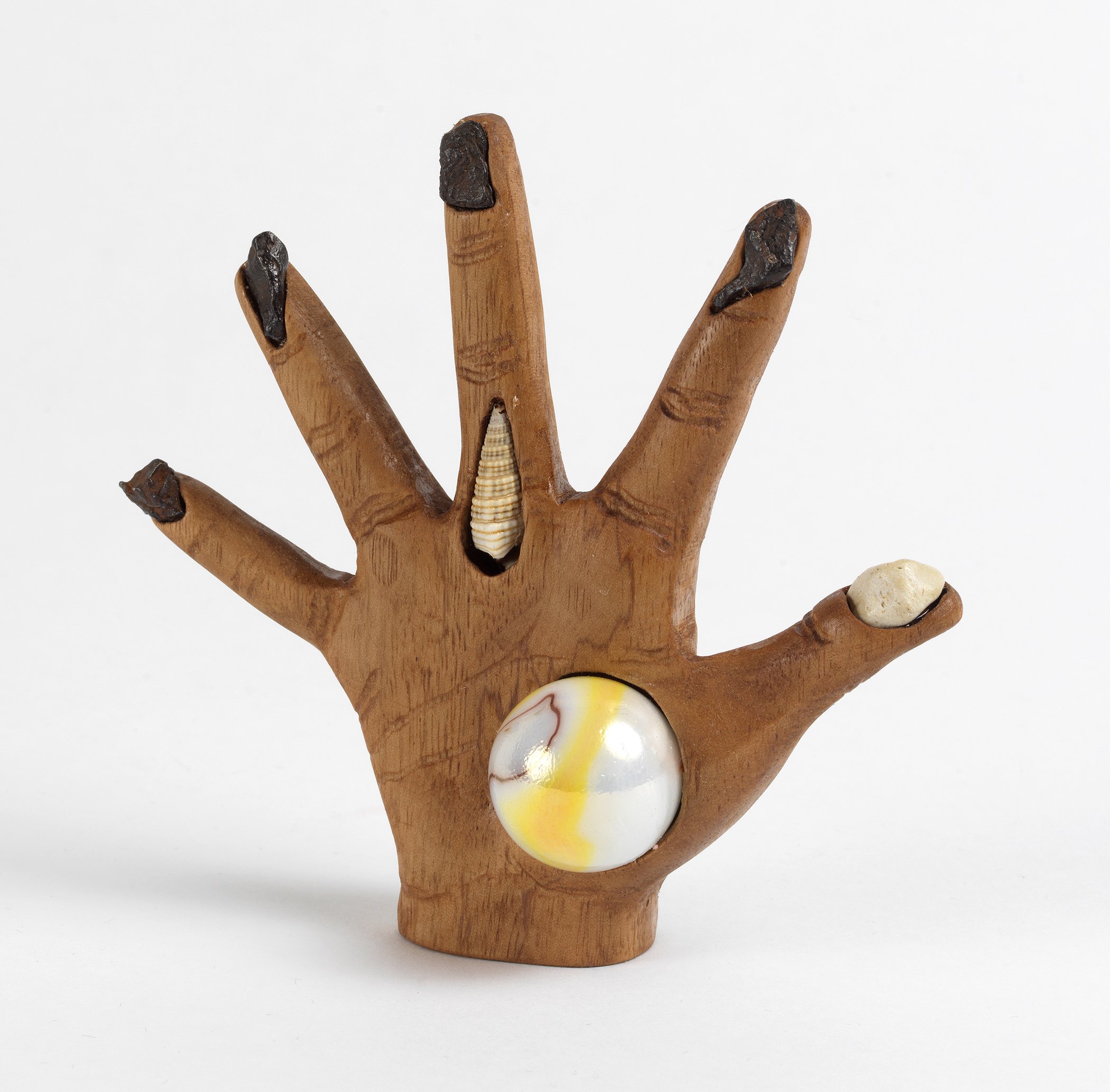   Witch’s Hand , 2020, meteorites, human tooth, shell, rock, and plastic head on carved walnut, 4.5” x 5” x 1.5” 