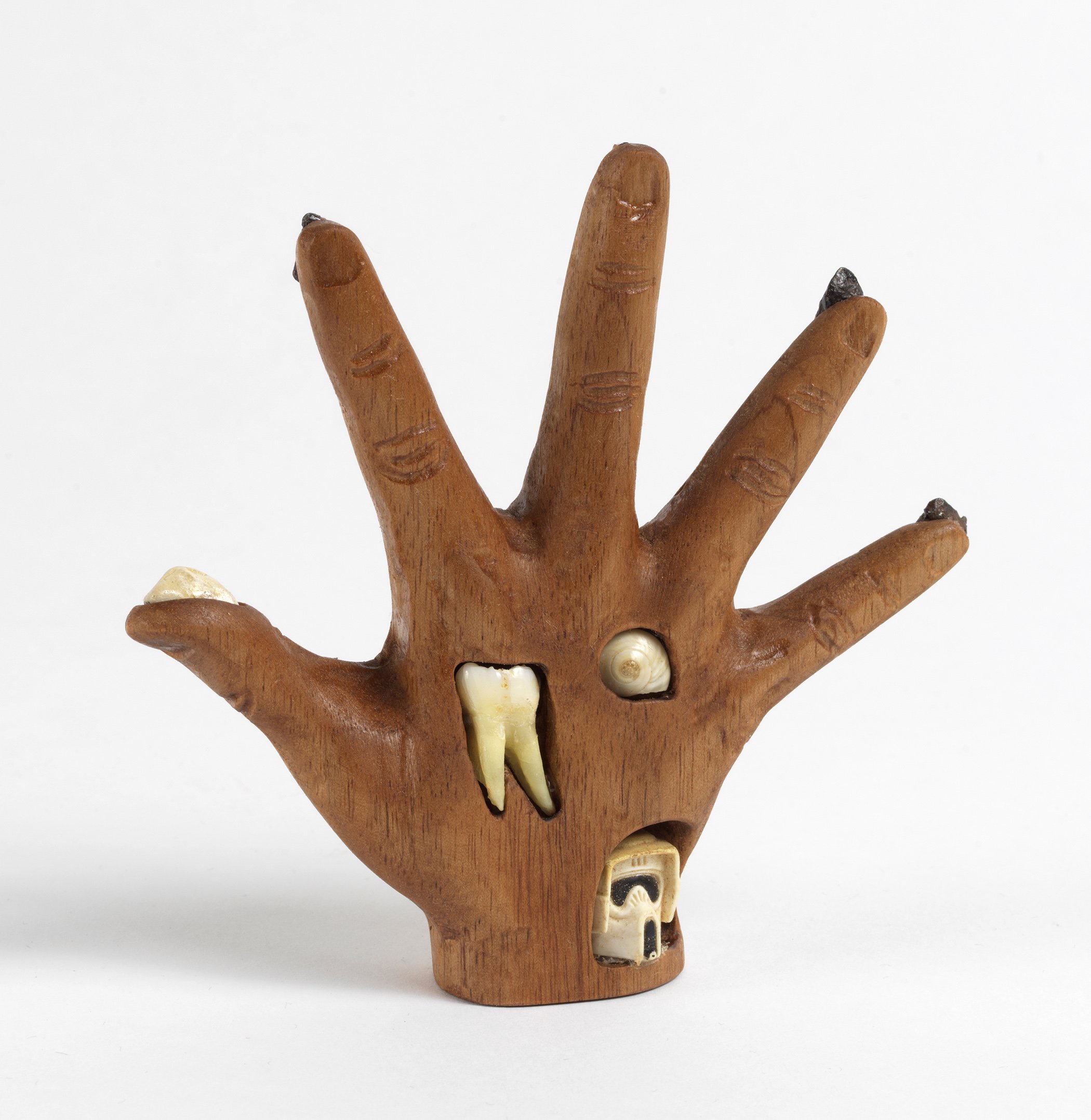  Witch’s Hand, 2020, meteorites, human tooth, shell, rock, and plastic head on carved walnut, 4.5” x 5” x 1.5” 