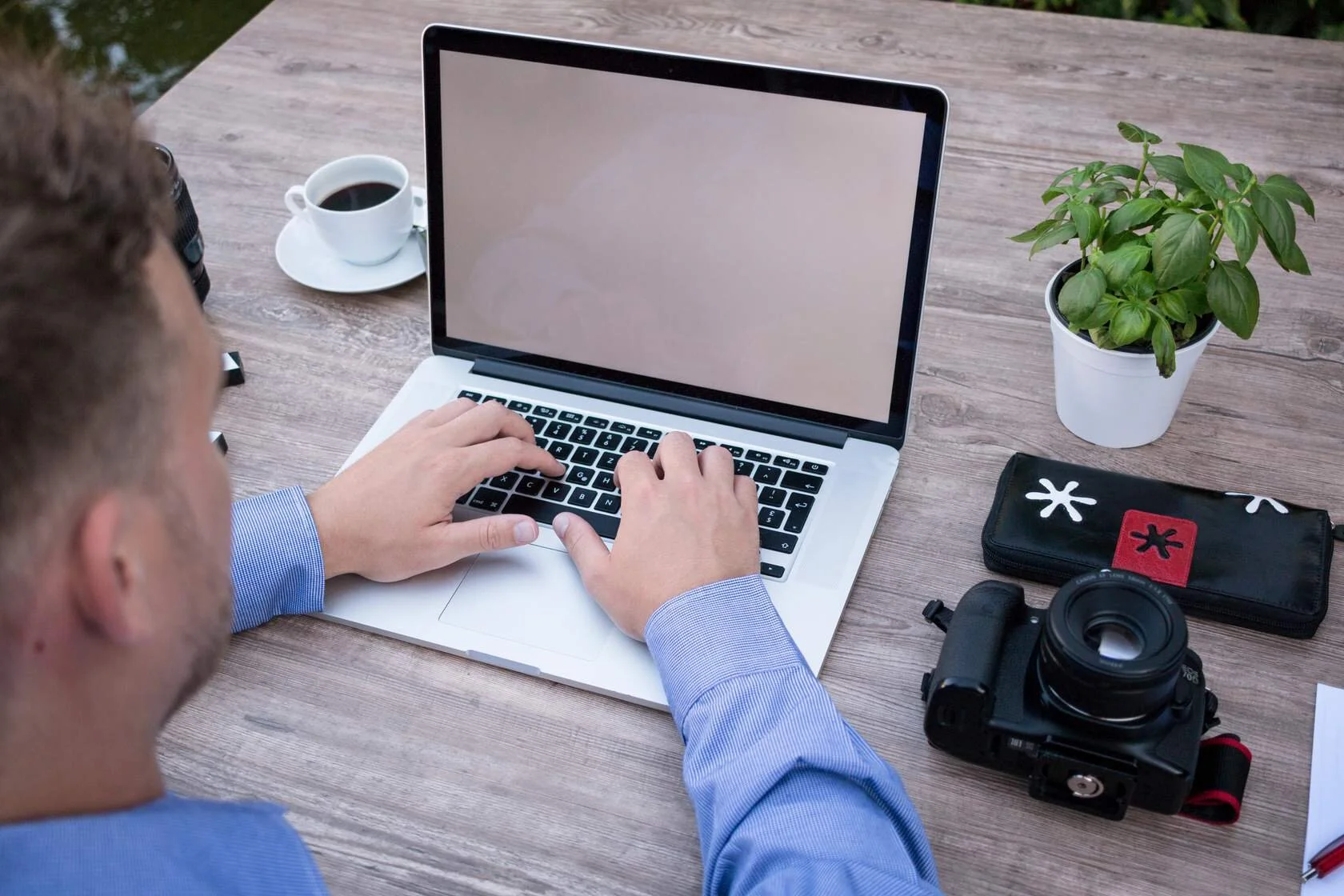 Guy on computer with camera .jpg