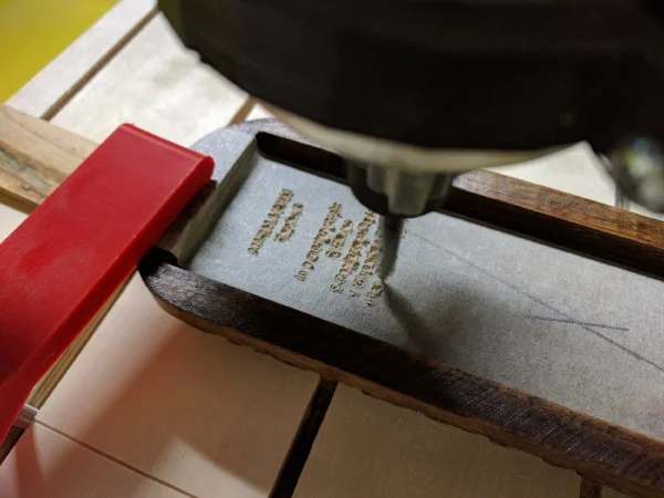  Engraving the text on the underside of the box lid. 