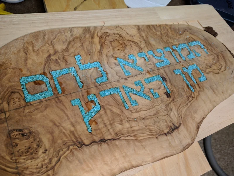  First course of inlay using crushed turquoise. &nbsp;The crushed stone is piled into the engraved letters and soaked with extra liquid cyanoacrylate glue. &nbsp;There are many great guides on YouTube on the process. 