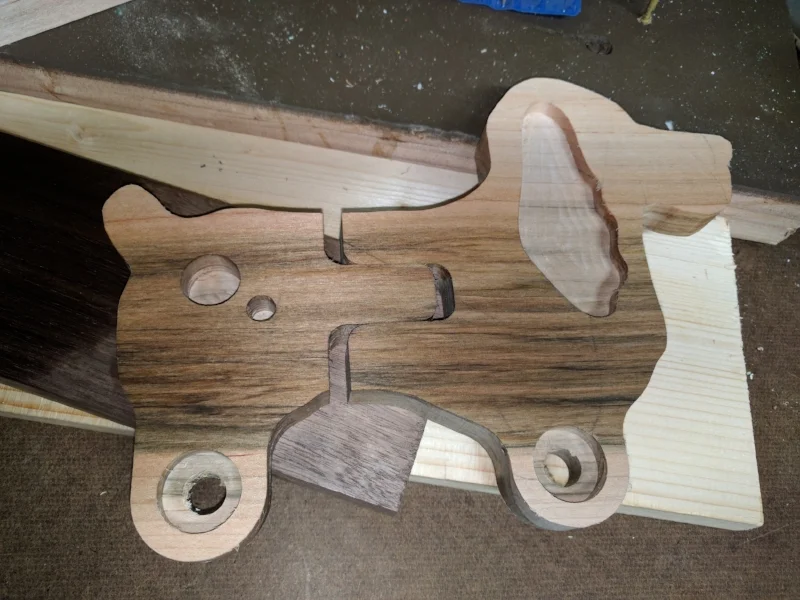 The board I bought was only 3/4" thick so I cut a mirror of each part and laminated them together. Doing this allowed me to machine in pockets for the inlays and extended hubs for the wheels.
