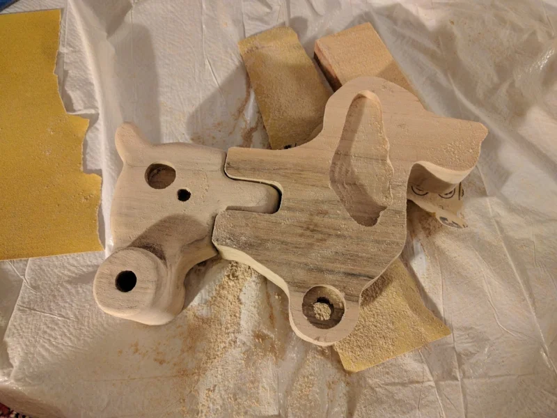  I added a hub extension to push the wheels away from the body and give the toy a wider, more stable base.&nbsp; In this photo you can see the sanding process on the rear of the toy. So, so much sanding.. 